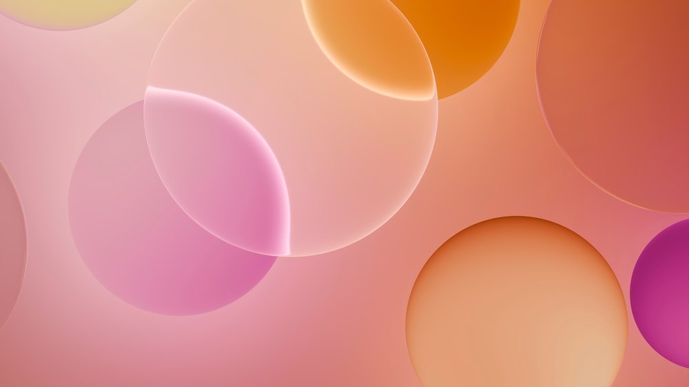 Abstract digital illustration of overlapping orange, pink, and purple spheres with soft glowing edges on a smooth gradient background.