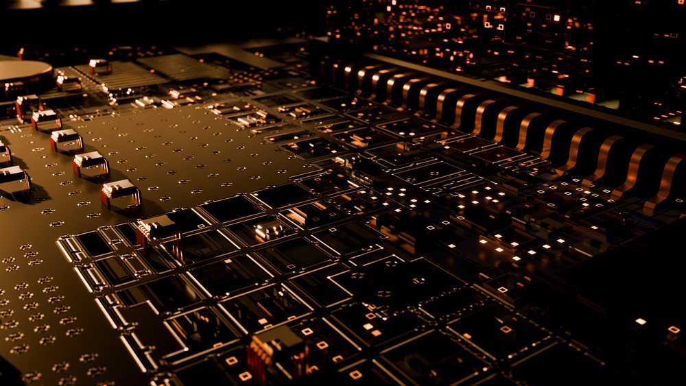 Close-up of a printed circuit board with electronic components and gold-colored accents showing technological equipment.