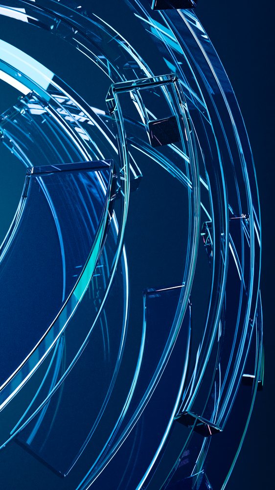 Curved transparent glass shapes with blue reflections form a modern abstract art installation under studio lighting.