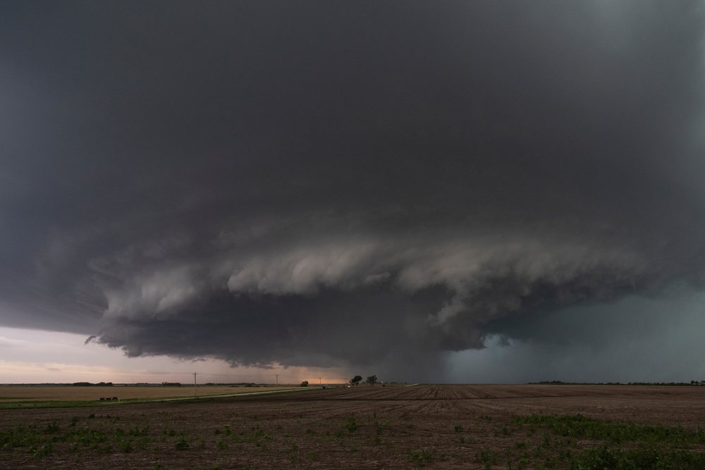 Supercell storm clouds with a visible rain shaft form over rural fields, Storm Chasing, Weather, Environmental Issues, Enterprise, Kansas, USA.