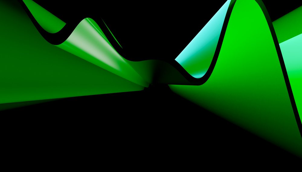 A green abstract wave with smooth curved shapes on a dark background, captured in a studio setting.