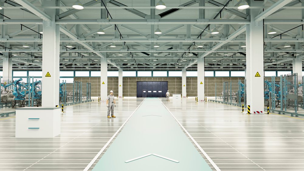Large car manufacturing factory interior with industrial robotic arms and workers wearing protective gear on the assembly line.