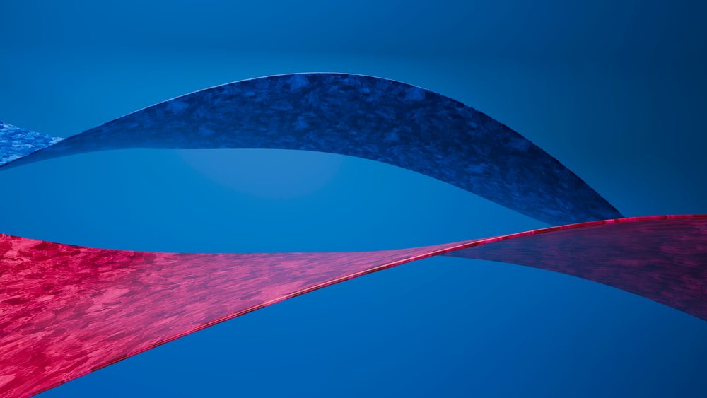 Large abstract outdoor sculpture featuring intersecting blue and red curved shapes against a clear blue sky.