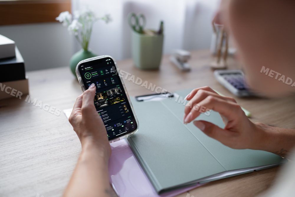 White Person using a home security application on smartphone