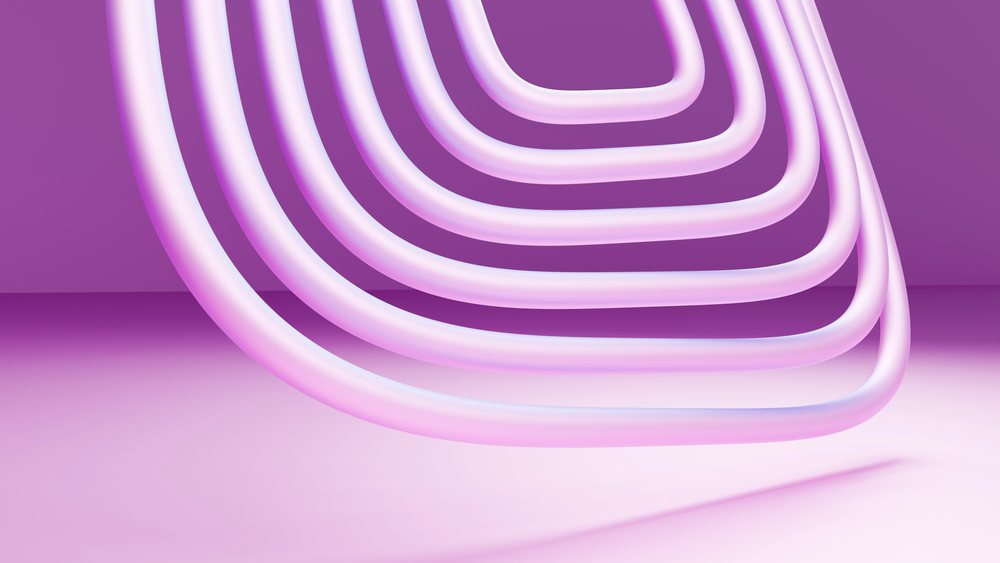 Abstract pink curved sculpture installation with geometric shapes set against a purple background and shaded floor.