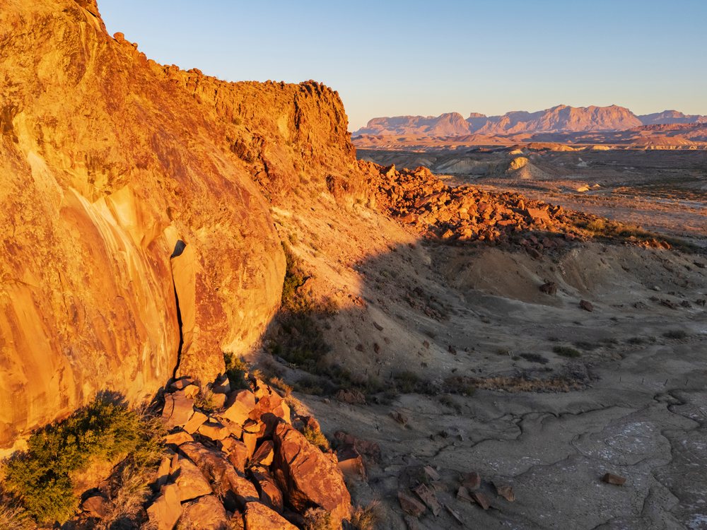 Chisos Mountain Range illuminated by golden sunlight at sunset with rocky desert terrain, landscape, wildlife, Study Butte, Texas, USA.
