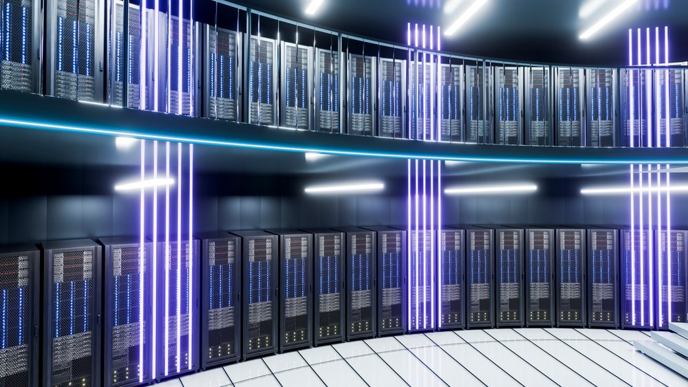 Circular data center room with rows of server racks and vibrant vertical LED lighting installations.