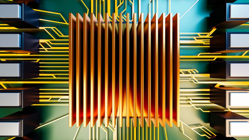 Close-up of a computer chip with a central heat sink mounted on a printed circuit board with surrounding electronic components.