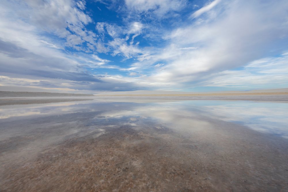 Sky and clouds reflected on the water surface in the desert landscape of, Alamogordo, New Mexico, USA.