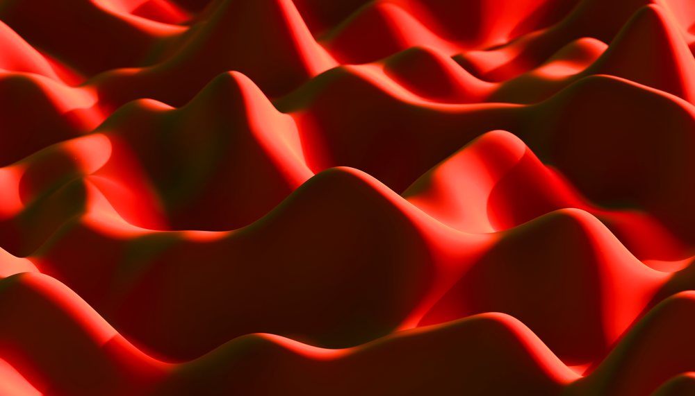 Abstract landscape of red, smooth, wavy hills creating a flowing, organic surface with light and shadow interplay.