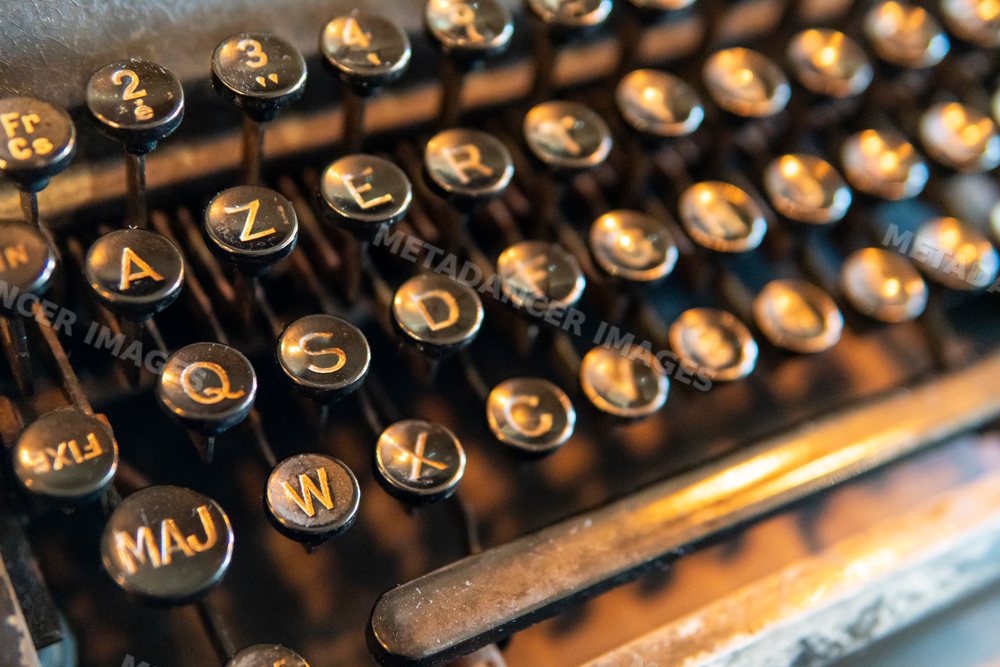 Close-up of black circular keys on a vintage retro typewriter