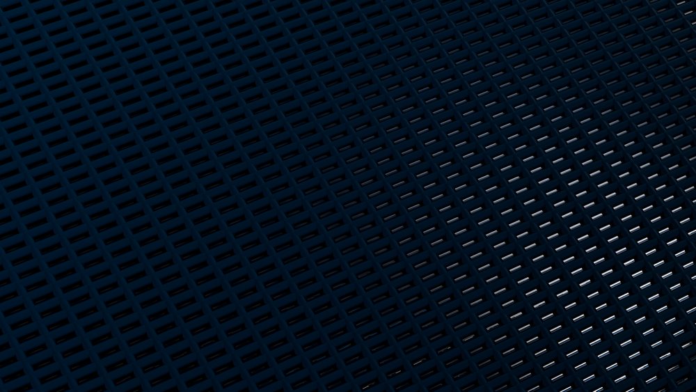 Metal grate with rectangular holes and textured surface creating a dark industrial pattern.