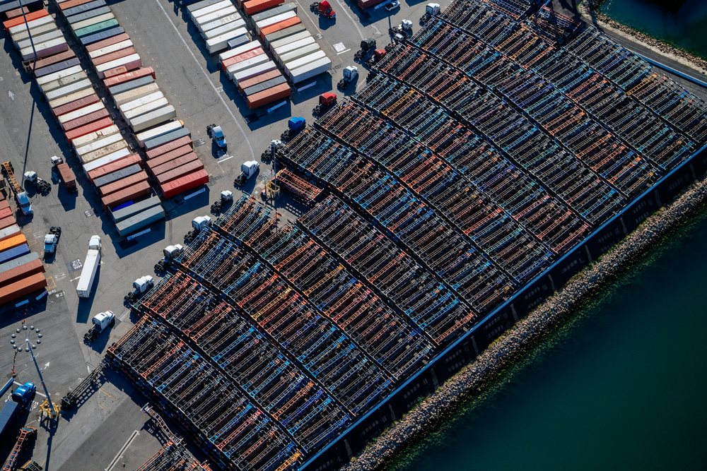 Aerial view of container ships and freight trucks at the dockyard, California, Port of Long Beach, CA, USA.