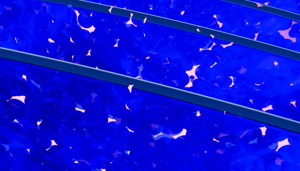 Blue translucent liquid bubbles forming layered abstract fluid shapes.