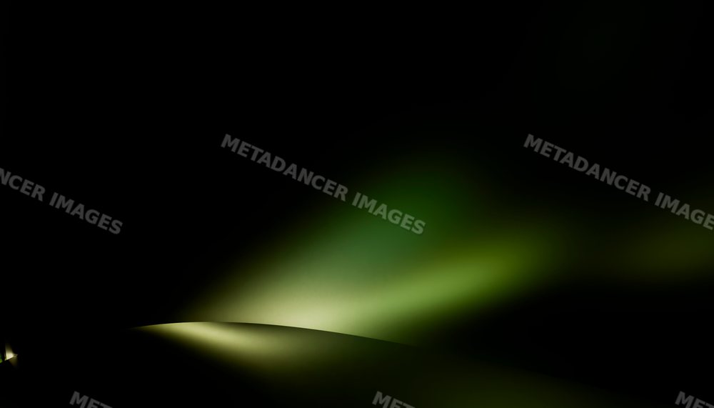 Soft green light fading into darkness creates an abstract background