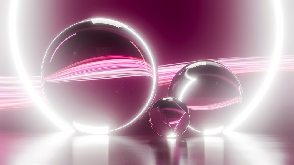 Three transparent glass spheres rest on a glossy surface.
