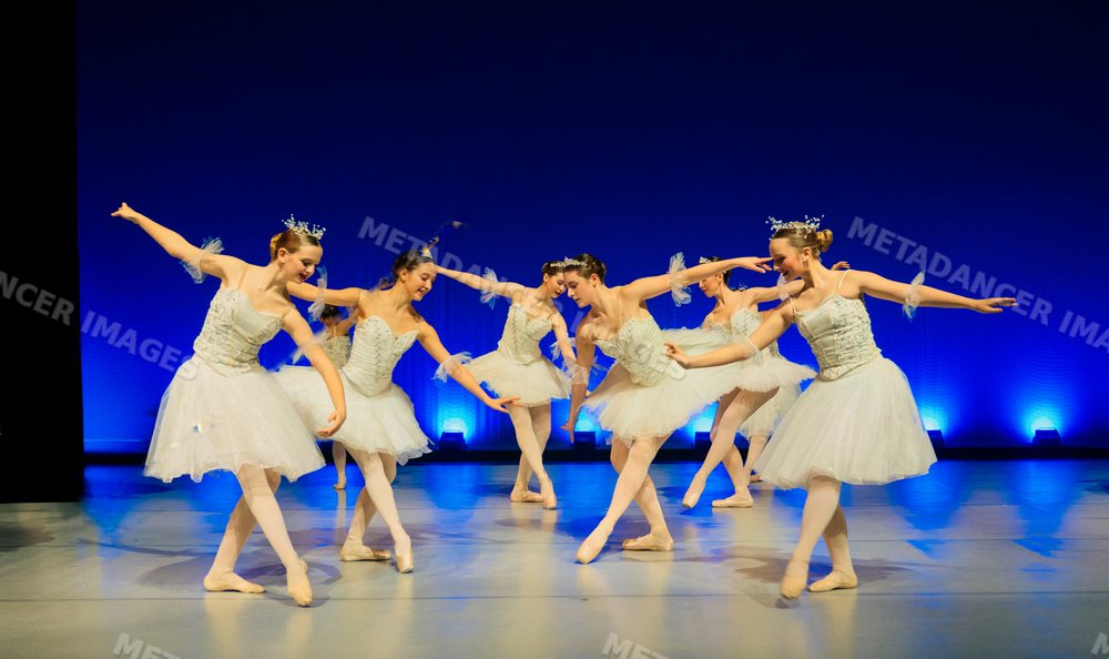 Young ballet dancers perform holiday-themed ballet on stage