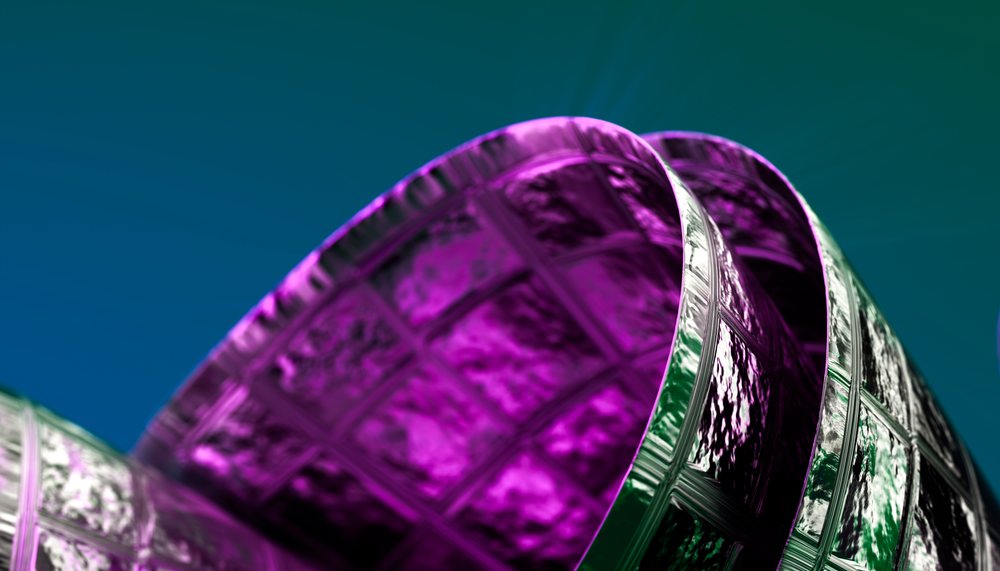 Close-up view of a purple glass cup with a textured pattern against a blue background.