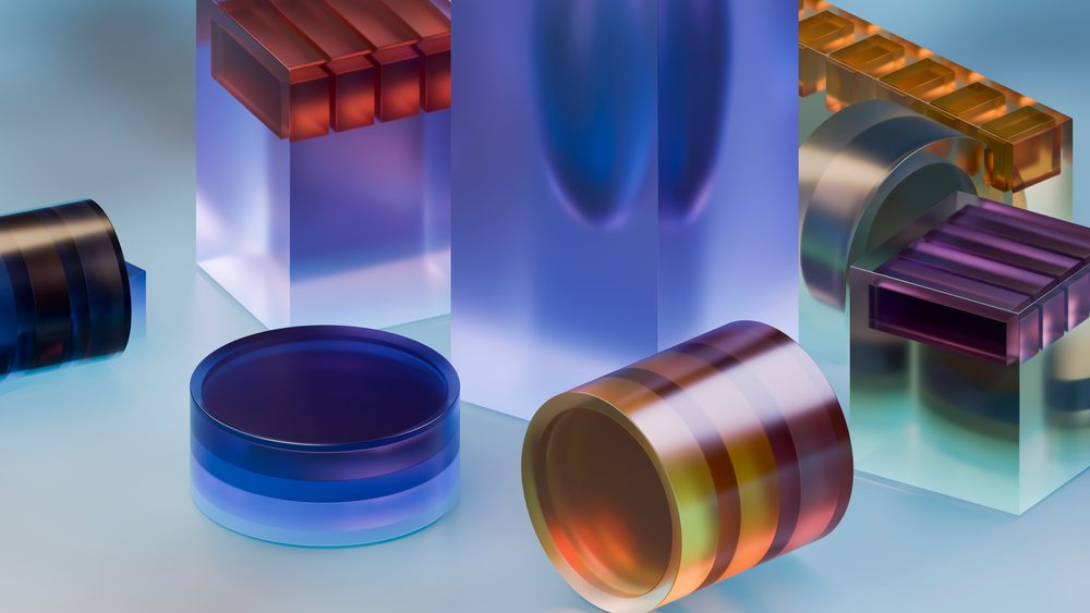 Colored glass blocks and abstract geometric shapes arranged as a modern artistic composition in a studio lighting setup.