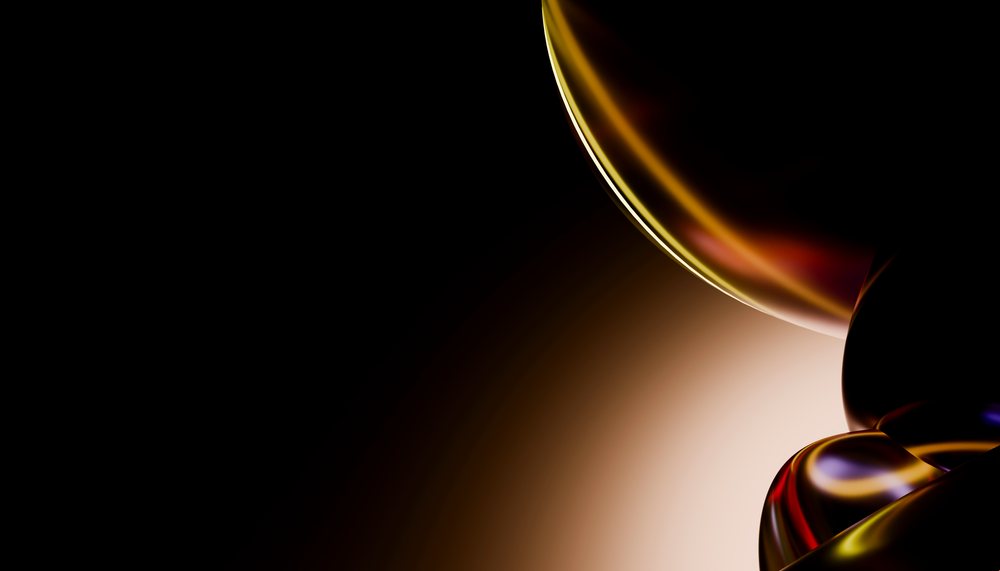 Abstract glossy spheres with colorful reflections on a dark background in a digital art 3D rendering.