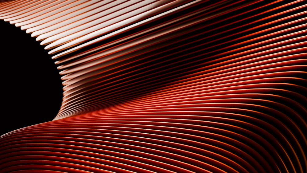 Digital illustration showing dynamic curved red and orange lines flowing on a black background.