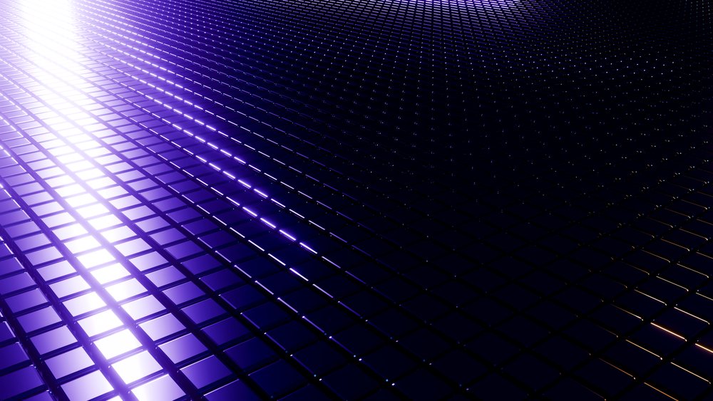 Digital grid of reflective blue 3D square tiles arranged uniformly with glowing light fading into black in an abstract futuristic pattern.