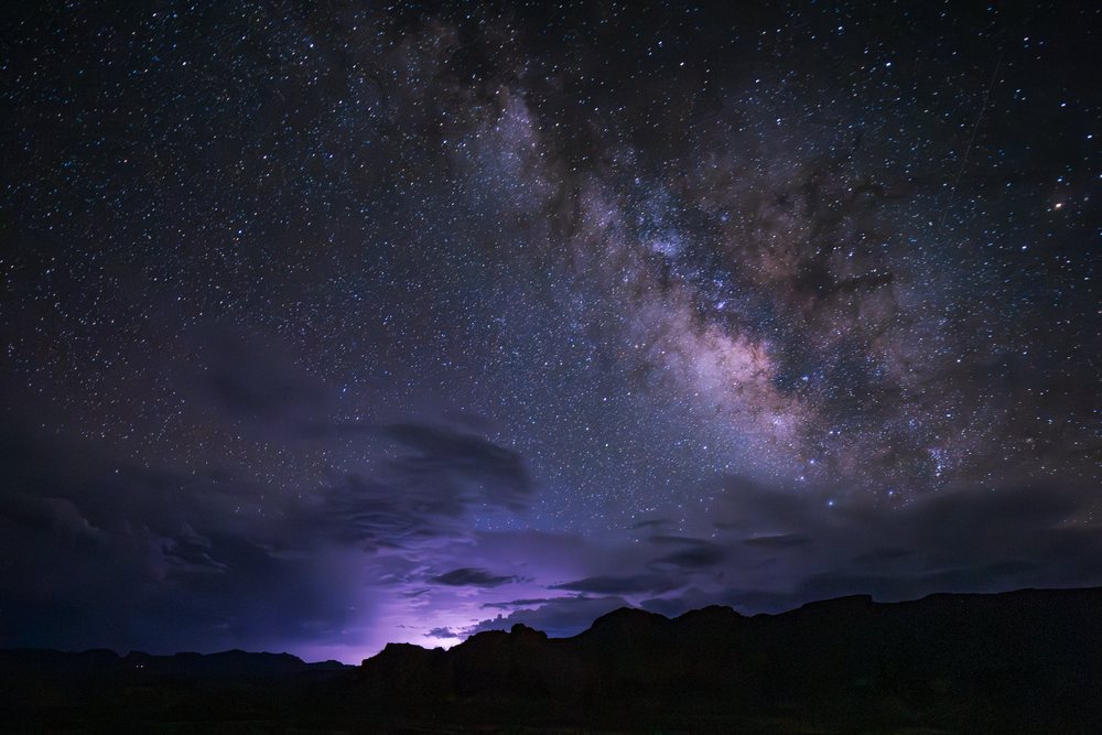 Starry night sky with the Milky Way and storm clouds over mountain silhouettes in Big Bend National Park, Landscape, Wildlife, Study Butte, Texas, USA.