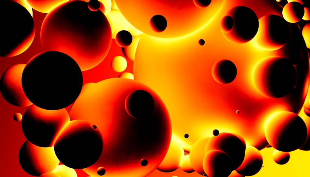 A visually striking digital illustration of glowing orange and red abstract spheres with black shadows floating against a bright background.