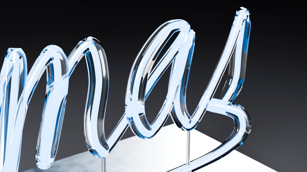 Glass neon sign spelling the word love glowing in blue light on a reflective surface against a dark background.