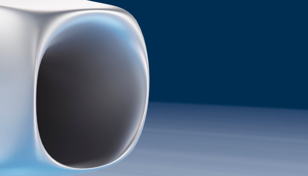 Close-up view of a jet engine inlet on an airplane against a blue background.
