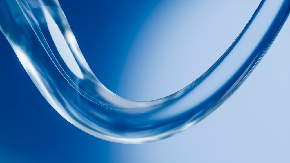 Curved transparent tube forms an elegant fluid shape against a blue gradient background with a smooth, shiny surface.