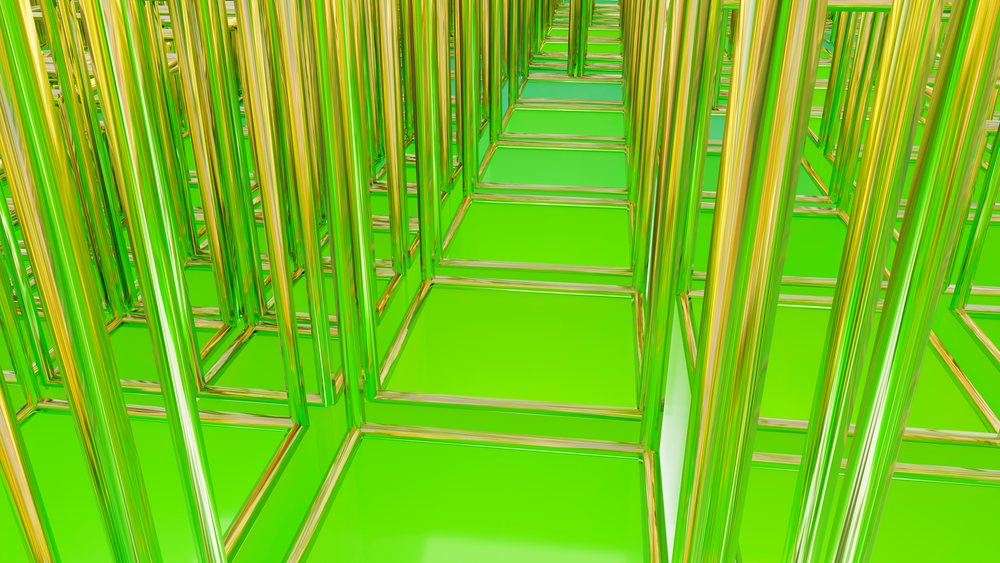 Transparent green glass cubes arranged in a geometric repeating pattern creating an abstract modern art design.