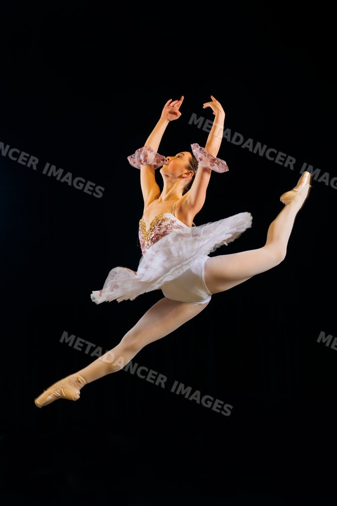Female ballet dancer performs a graceful leap