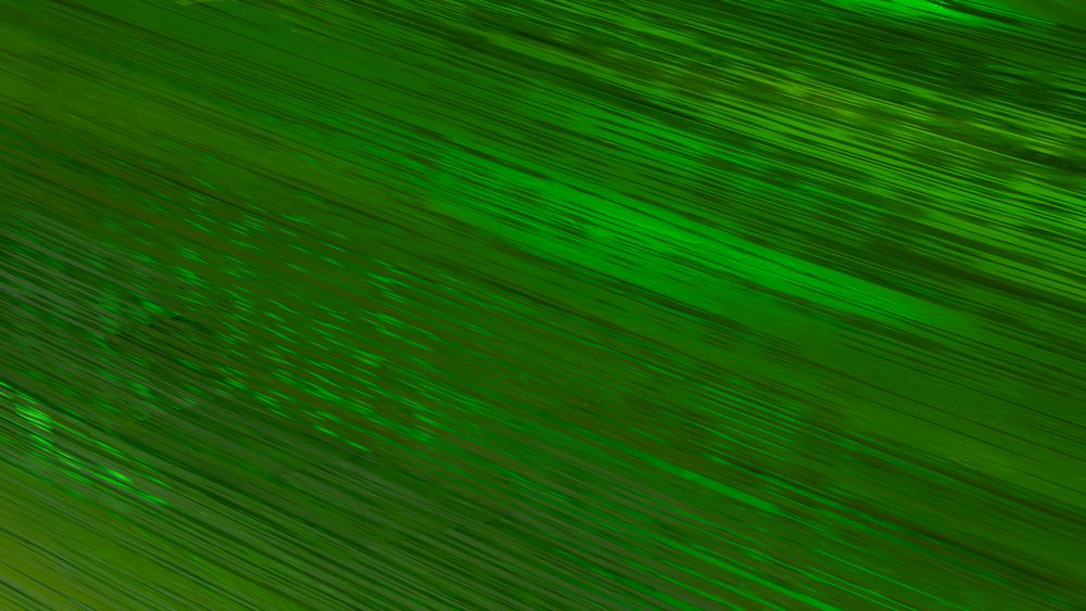 Digital illustration featuring green diagonal lines with a textured surface forming an abstract pattern.