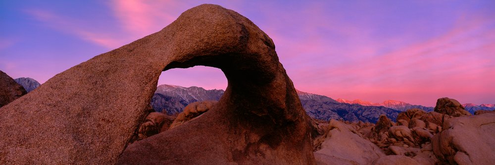 Granite Arch rock formation with Sierra Nevada mountains at sunrise, California, USA.