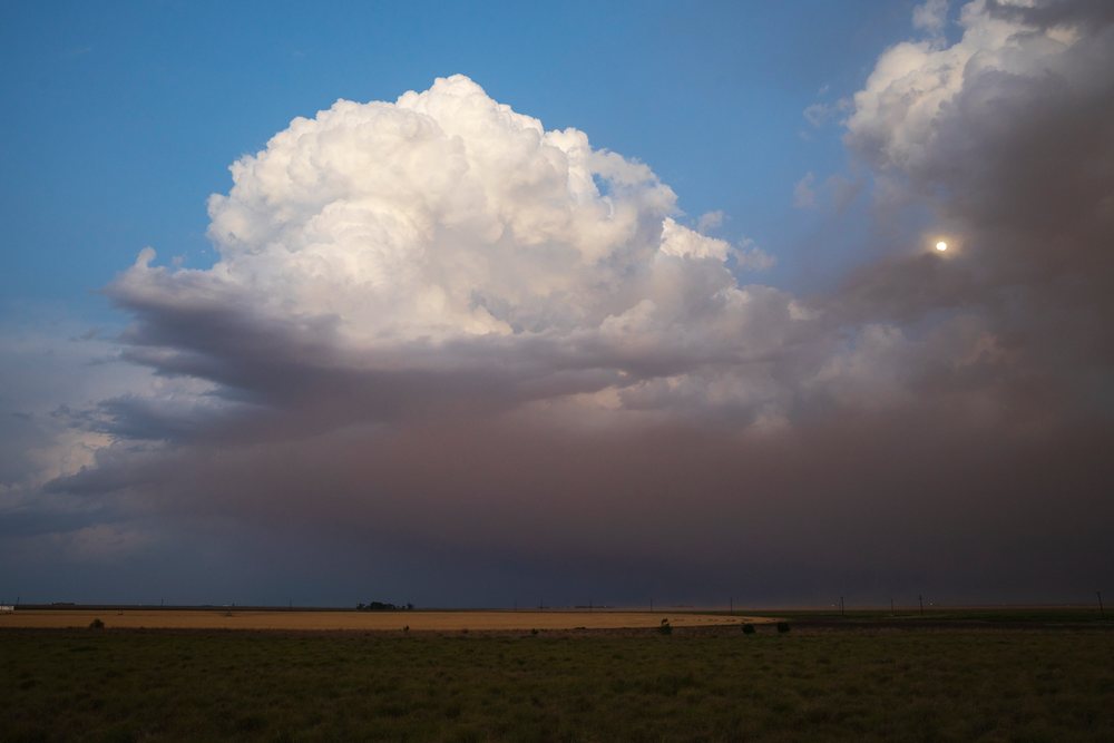 Dust storm unfolds at Sunset with dramatic clouds over the Great Plains, Post, Texas, USA.