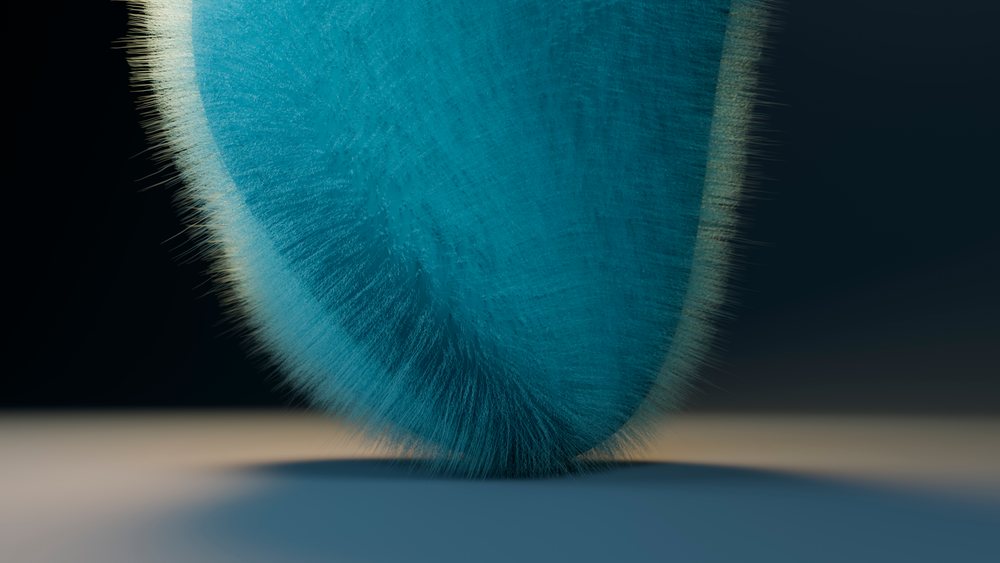 Blue abstract sculpture with fine furry texture and curved shape isolated against black background under studio lighting.