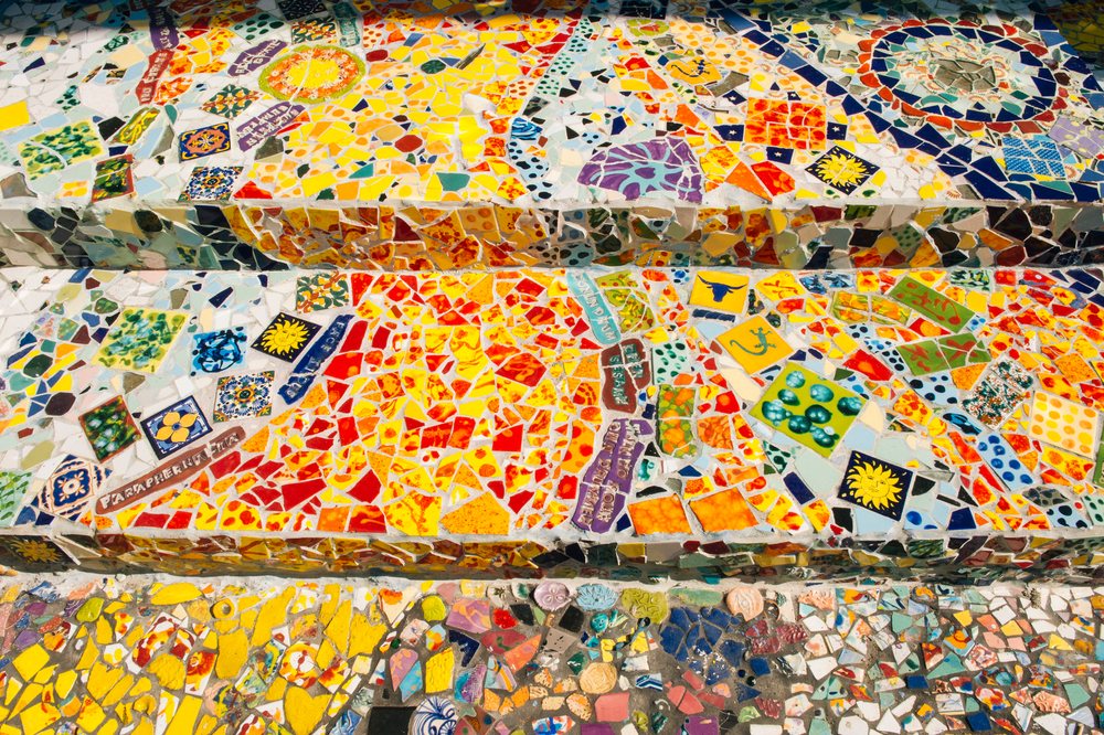 Colorful mosaic staircase decorated with vibrant ceramic tiles in geometric and floral patterns, CA, USA.