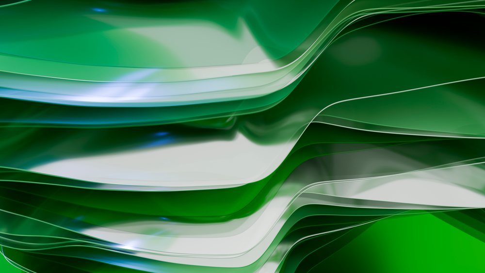 Curved layers of transparent green glass sheets creating an abstract modern composition.