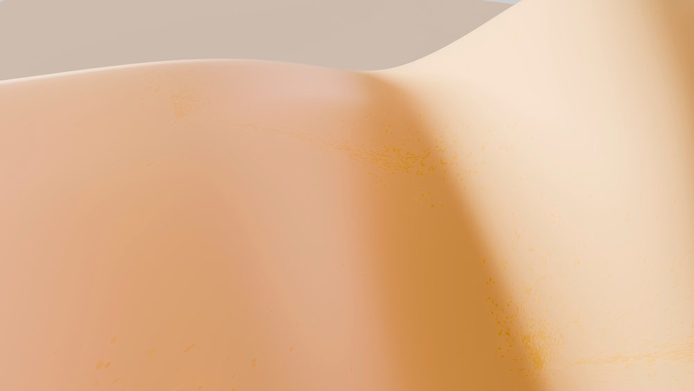 Sand dunes illuminated by warm sunlight under a clear sky in a desert landscape.