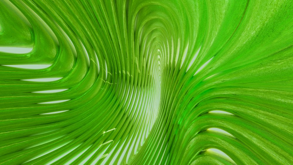 Green abstract curved shape with smooth texture and flowing lines in a modern artistic design.