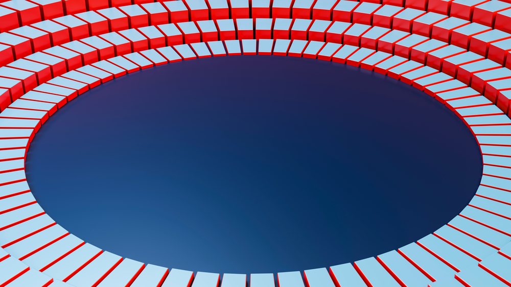 Abstract circular pattern featuring symmetrical shiny red and white 3D blocks arranged in curved rows around a deep blue center.