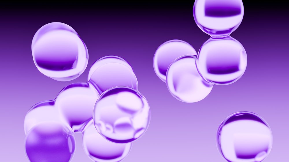 Purple transparent bubbles floating as spheres in an abstract 3D rendering on a purple background.