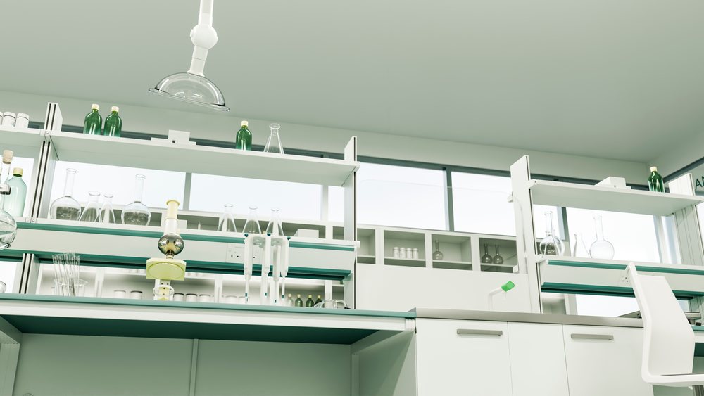 Laboratory workbench with glass beakers, bottles, and pipettes under natural window lighting in a clean, modern research environment.