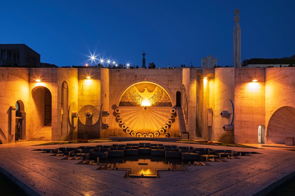 The Cascade monumental limestone staircase with fountains and sculptures lit at evening, Yerevan, Armenia.
