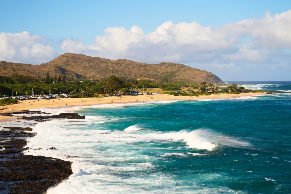 Scenic beach with waves and mountains, Oahu, Hawaii, USA.