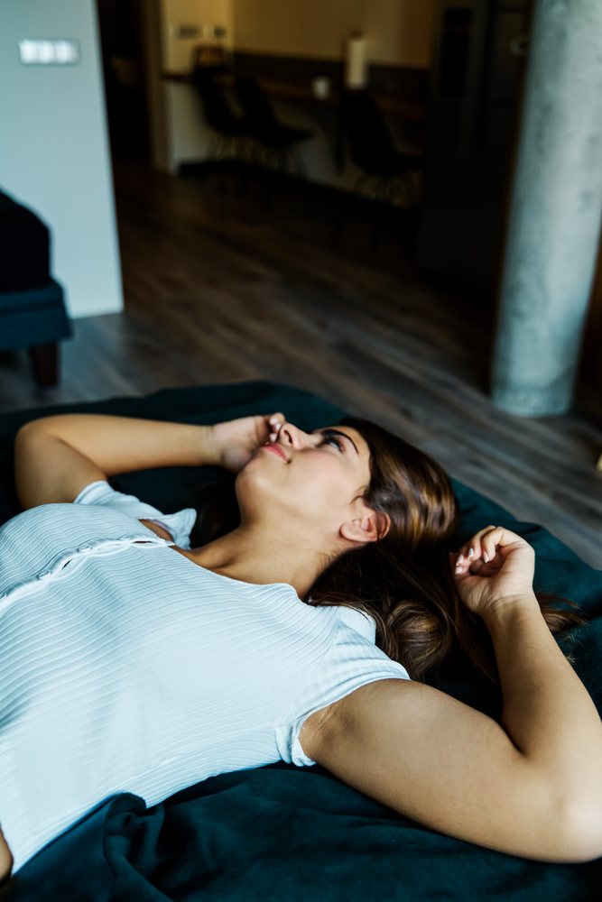 A woman lays down and relaxes inside a modern home interior in a hotel