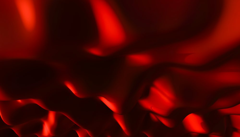 Abstract smooth red undulating waves creating a glossy fluid texture.