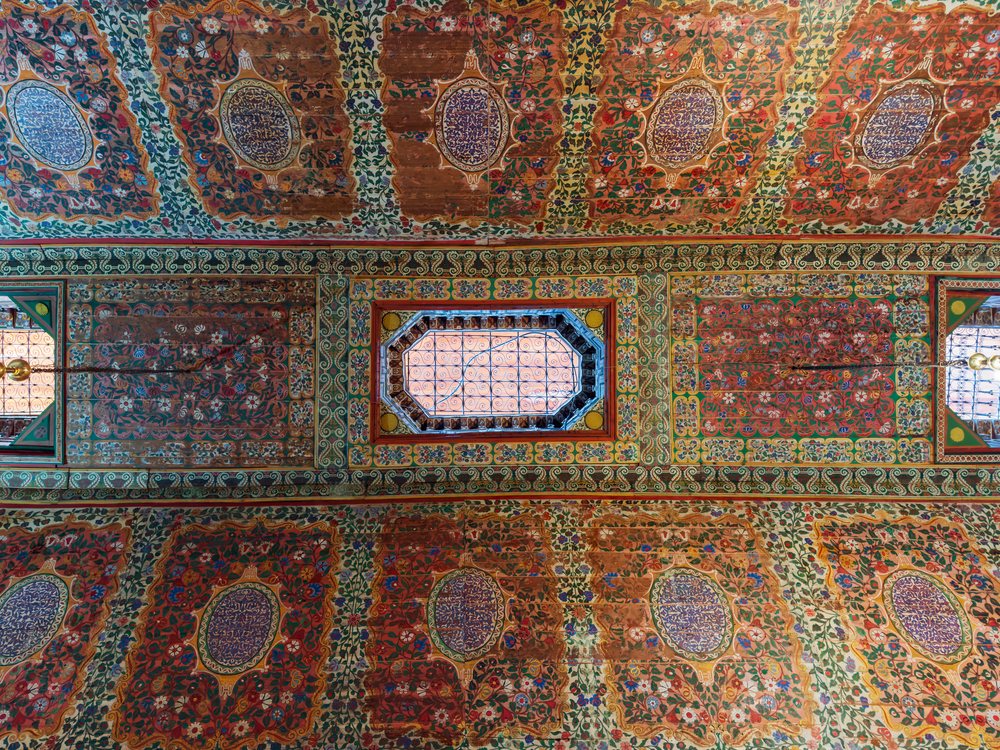 Ceiling Detail, intricate colorful floral and geometric ceiling patterns with an octagonal window inside Bahia Palace, Lifestyle, Landscape, Culture, Marrakech, Marrakesh-Safi Region, Morocco.