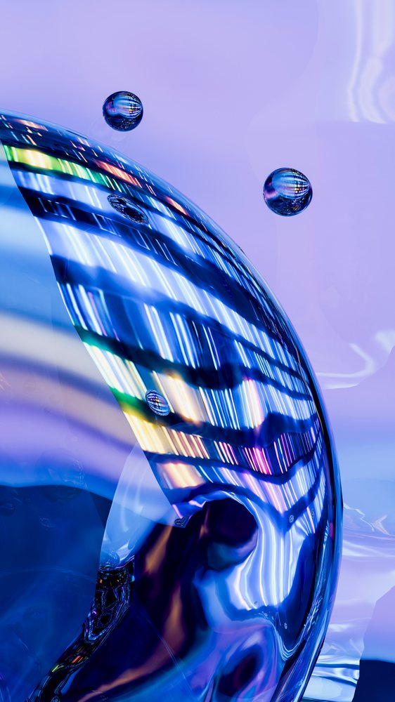 Colorful abstract reflections and refractions on translucent bubbles against a blue background.